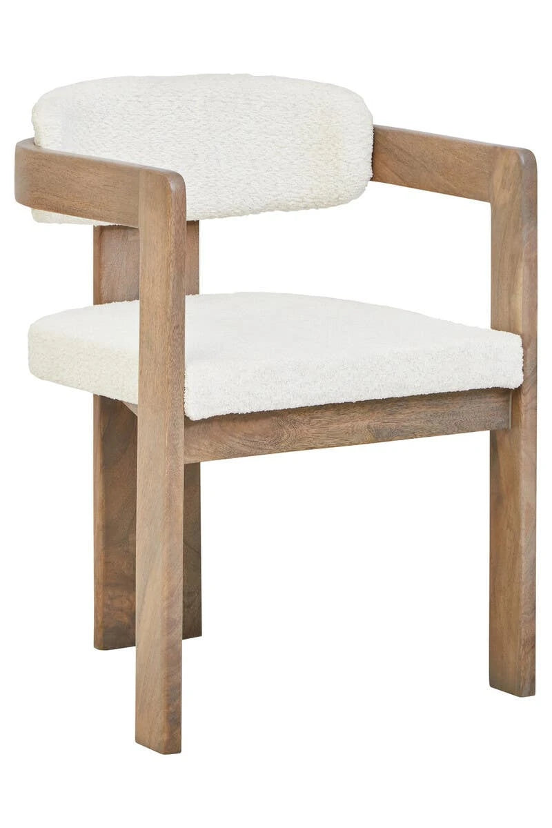 The Hawthorn Grey Mango Wood Dining Chair from a three-quarter angle, with its grey-washed frame wrapping around to form slim armrests.