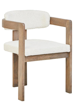 The Hawthorn Grey Mango Wood Dining Chair from a three-quarter angle, with its grey-washed frame wrapping around to form slim armrests.