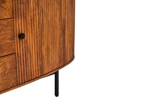 Close view of a reeded door on the Hawthorn Oval Sideboard with a black knob, above a slim black metal leg.
