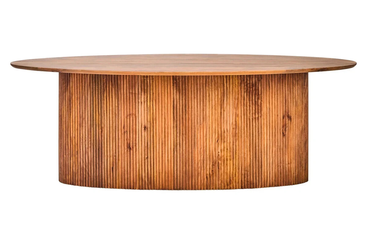 Side view of the Hawthorn Mango Wood Oval Dining Table, showing the long oval top above a reeded oval base.