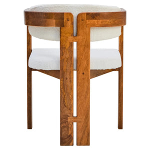Back view of the Hawthorn Dining Chair, showing the sculptural split back leg and joinery detail in solid mango wood.