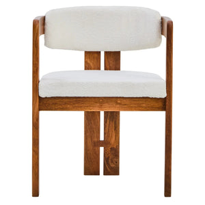 Front view of the Hawthorn Dining Chair, showing the cream bouclé seat and curved backrest in a warm mango wood frame with split back legs.