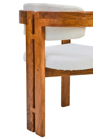 Rear corner of the Hawthorn Dining Chair, showing the split mango wood back leg and the curve of the frame.