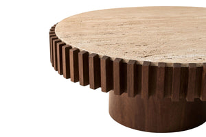 Close-up of the travertine top and ribbed mango wood edge on the Solmere round coffee table