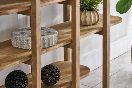 Rustic open shelving unit with decorative items against a white wall and a grey floor