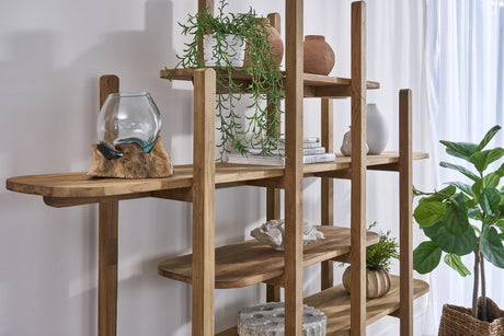 Wooden shelf with decorative items and plants against a white wall