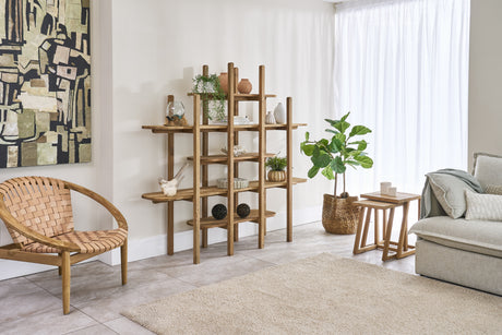 Living room with wooden shelf, wicker chair, and gray sofa.