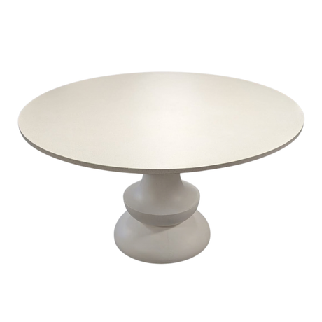 A round pedestal dining table with a smooth, matte off-white finish, shown against a plain white background.