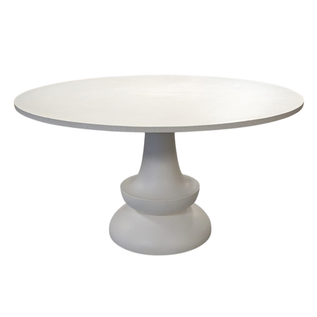 A modern round dining table with a smooth white top and a sculptural pedestal base, shown against a plain white background.