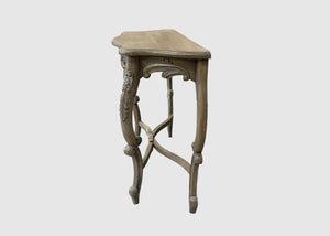 A small carved wooden side table with a hexagonal top and ornate cabriole-style legs, shown against a plain light gray background.