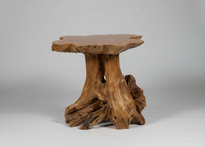 Wooden side table with natural, organic design on a gray background