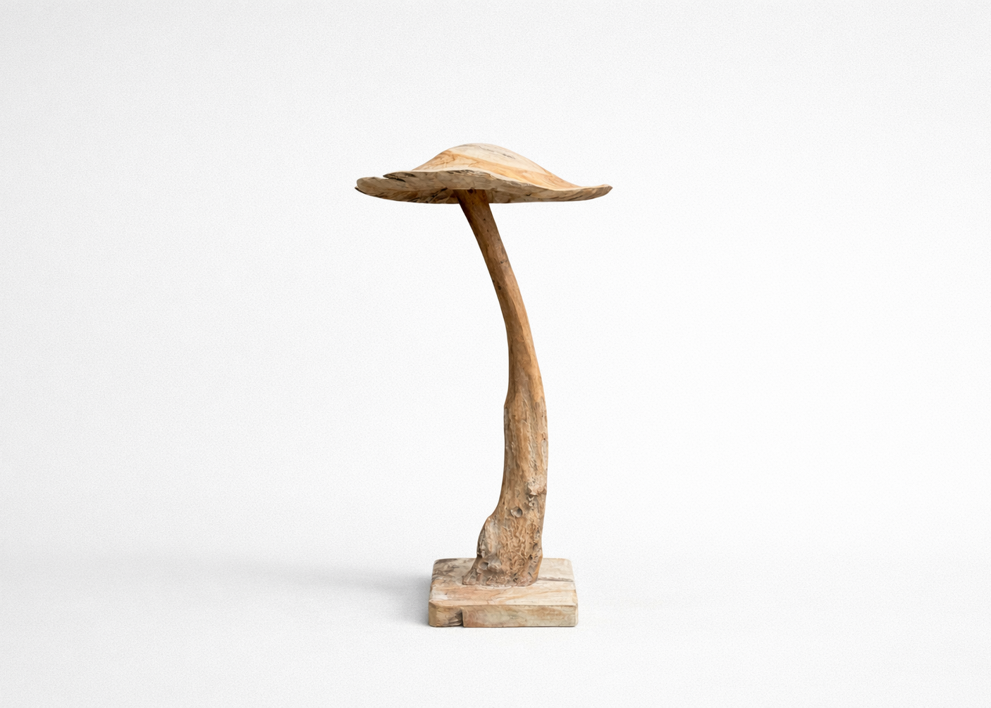 Wooden sculpture resembling a mushroom on a white background