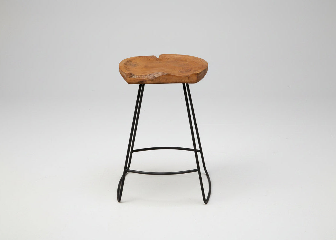Wooden stool with black metal legs on a white background