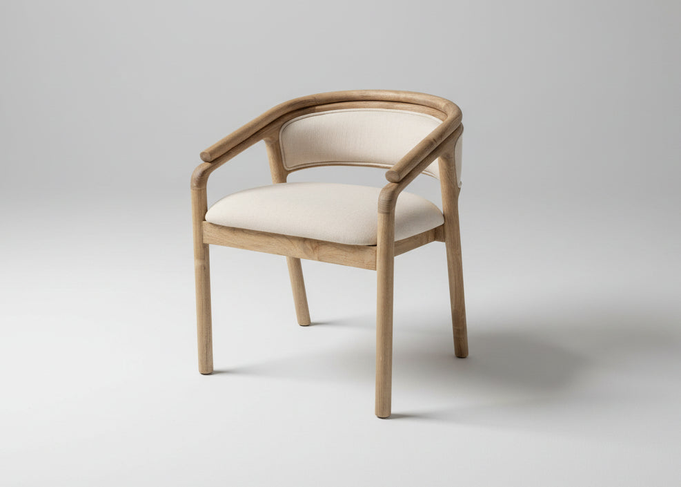 A modern accent chair with a curved light oak wood frame and cream-colored fabric upholstery on the seat and backrest, shown against a neutral light grey studio background.