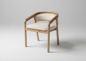 A modern accent chair with a curved light oak wood frame and cream-colored fabric upholstery on the seat and backrest, shown against a neutral light grey studio background.