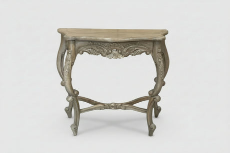 An ornate console table with a distressed gray wood finish, featuring carved details on the apron and legs, set against a plain light gray background.