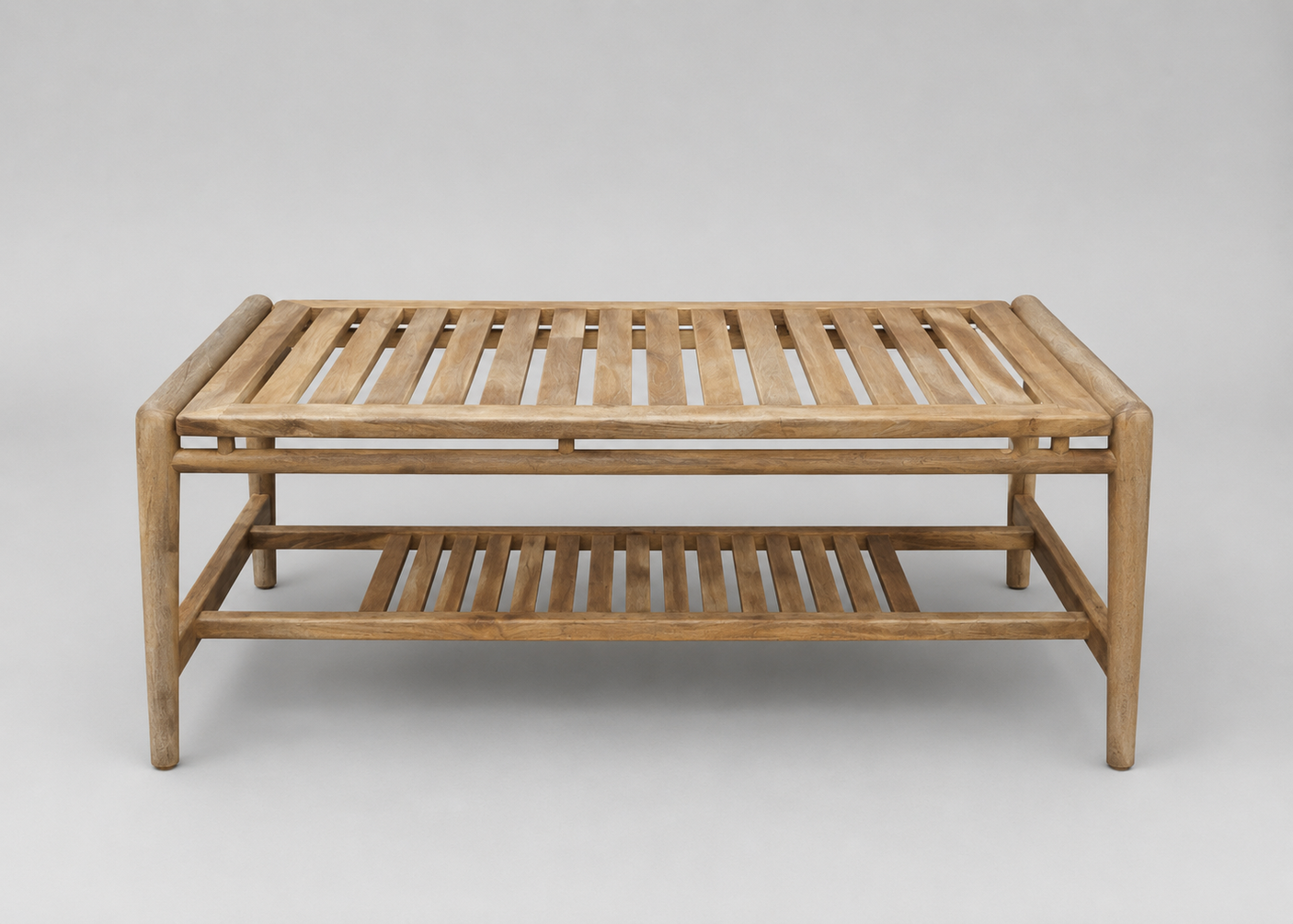 A rectangular wooden slatted coffee table with a lower shelf, shown against a neutral light grey studio background.