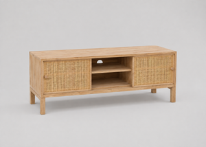 A light natural wood TV stand or media console with woven rattan panel doors and an open centre shelf, photographed on a plain light grey studio background.