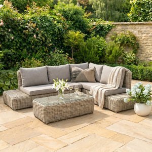 Amalfi outdoor patio set with wicker furniture and cushions on a stone patio.
