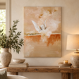 Ascend painting of a winged ivory figure in warm ochre and burnt orange above a rustic console table with a stone lamp and olive branches