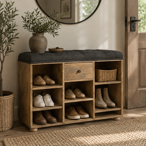 Natural wood shoe storage bench with charcoal cushion in a rustic entryway