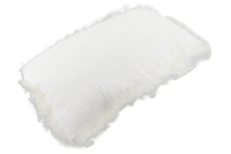 Rectangular White Linen Cushion With Sheepskin Trim shown at an angle, with its crinkled linen front and fluffy sheepskin trim