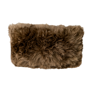 Rectangular Light Brown Sheepskin Cushion with long brown wool, on a dark background