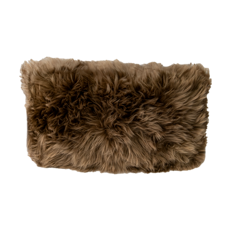 Rectangular Light Brown Sheepskin Cushion with long brown wool, on a dark background
