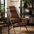 Brown leather armchair in a cozy room with books and plants
