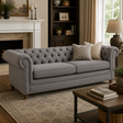 Esme three seater grey linen chesterfield sofa in a cosy room setting