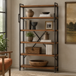 A tall six-tier wooden bookcase with black metal frame supports, styled with books, vases, a basket, and a bowl in a warm, neutral-toned room.