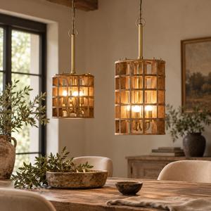 Two Gerai Natural Mango Wood Grid Ceiling Lamps lit over a rustic wooden dining table with olive branches