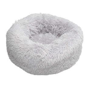Grey Faux Fur Donut Dog Bed, a round bed covered in long shaggy pale grey faux fur, on a white background