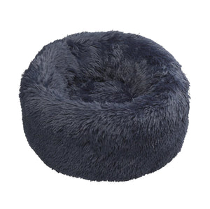 Navy Faux Fur Donut Dog Bed, a round bed covered in long shaggy navy faux fur, on a white background