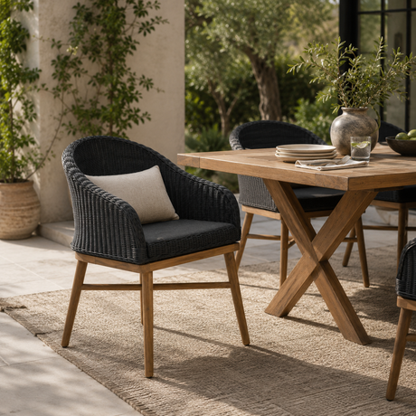 Harris outdoor furniture set with dark grey wicker chairs and a wooden table on a patio.