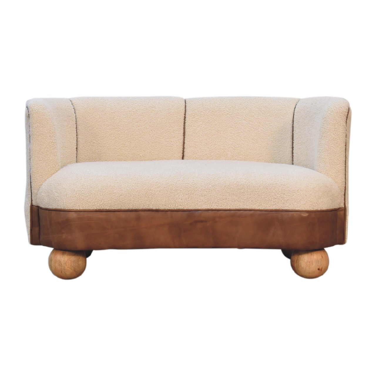 A beige and brown sofa with a boucle texture and buffalo hide leather seat, supported by round wooden legs.