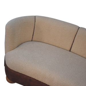 A cream boucle sofa with buffalo leather detail