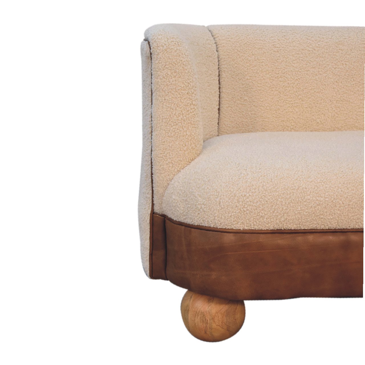 View of the side of a buffalo leather sofa with cream boucle upholstery