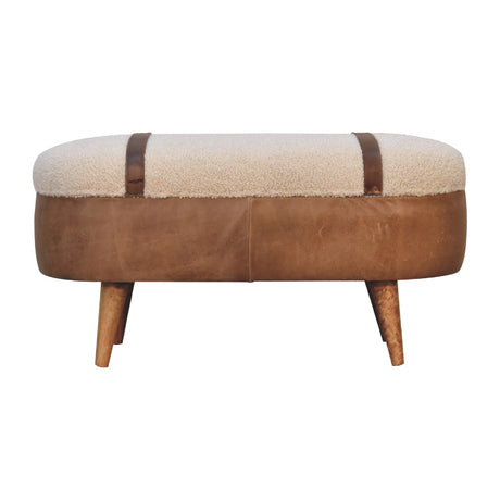 A beige boucle seat bench with brown buffalo leather straps and a wooden base with four legs.