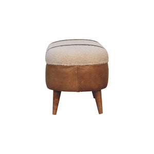 End view of a beige boucle seat bench with brown buffalo leather straps and a wooden base with four legs.