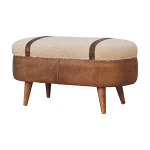 A beige boucle seat bench with brown buffalo leather straps and a wooden base with four legs on a white background