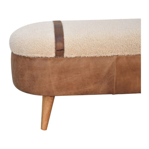 Close up of a beige boucle seat bench with brown buffalo leather straps and a wooden base with four legs.