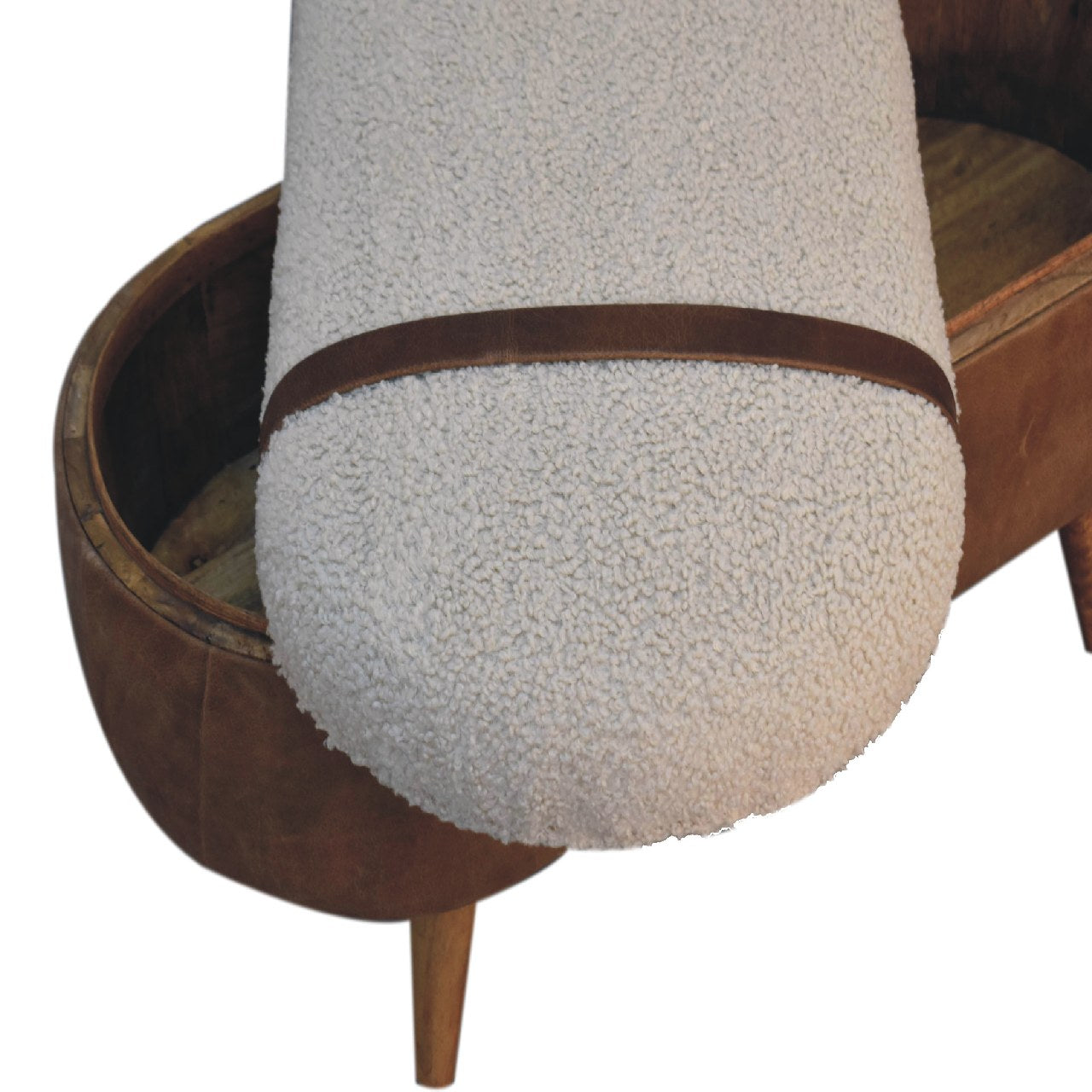 A beige boucle seat bench with brown buffalo leather straps and a wooden base with four legs with the removable top sitting across the base