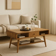 Wooden coffee table in a living room with a beige sofa and decorative items.