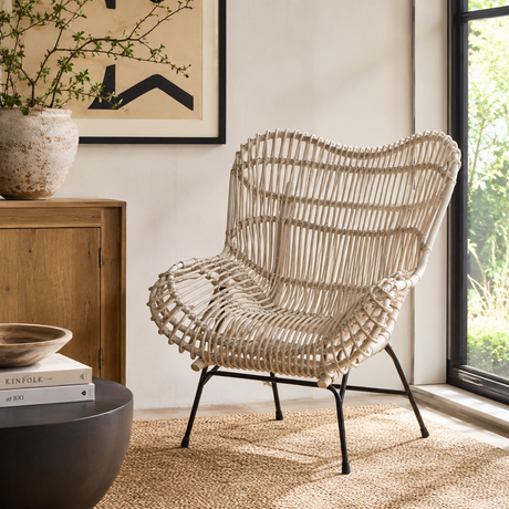 Wicker chair in a room with a window and decor