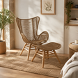 Nomad latte rope lounge chair and footstool in a room setting with warm sunlight