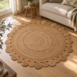 Looma Round Jute Rug with Circular Edges on a wooden floor in front of a cream sofa, beside a small wooden stool