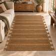 Nexo Large Striped Rug on a stone floor beside a cream sofa with a green throw, with a wooden sideboard behind