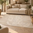 Tierra Small Natural Hair On Leather Rug on a stone floor in front of a cream sofa, with an olive tree and ceramic lamp behind