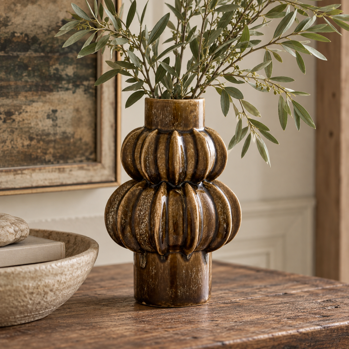 Orsa Brown Stoneware Bubble Vase with its glossy, stacked ribbed form, styled in a warm, neutral interior.